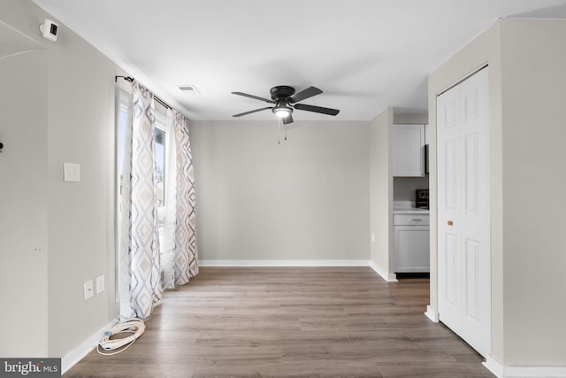 empty room featuring hardwood / wood-style flooring and ceiling fan