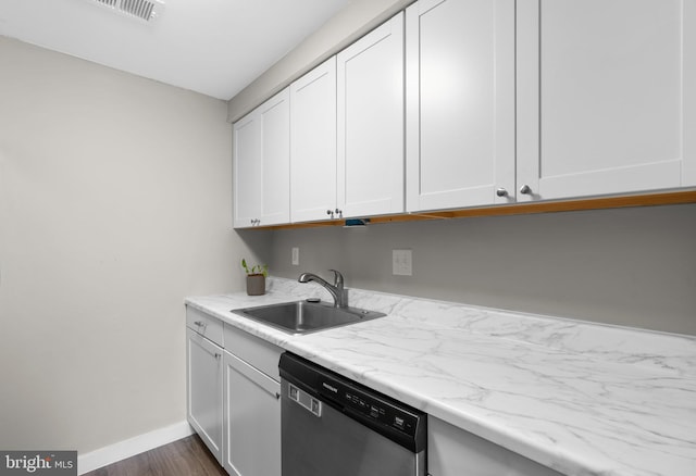 kitchen with sink, dishwasher, light stone counters, white cabinets, and dark hardwood / wood-style flooring