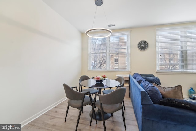 dining space with light wood-type flooring