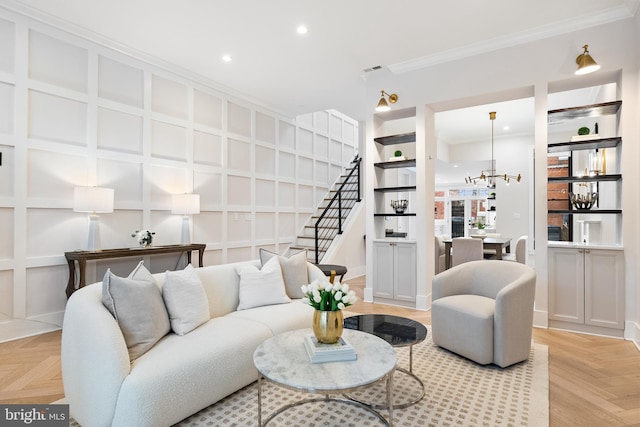 living room with crown molding and light parquet flooring