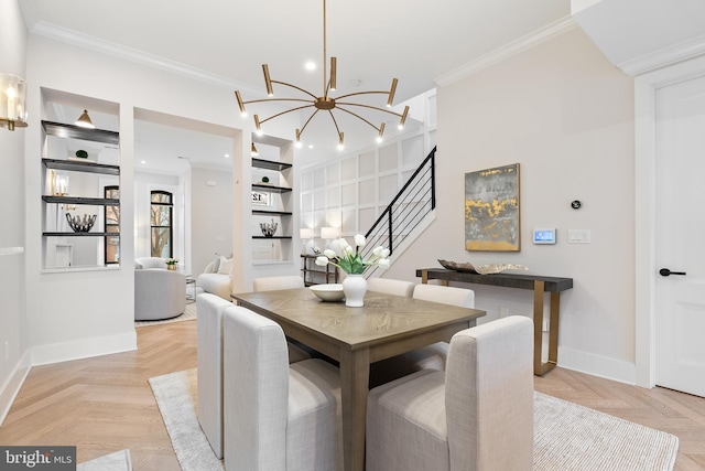 dining room featuring a notable chandelier, crown molding, and light parquet floors