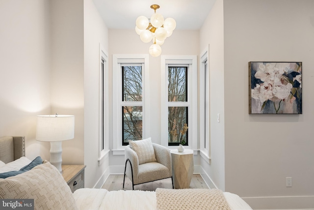 bedroom featuring light hardwood / wood-style flooring and a notable chandelier