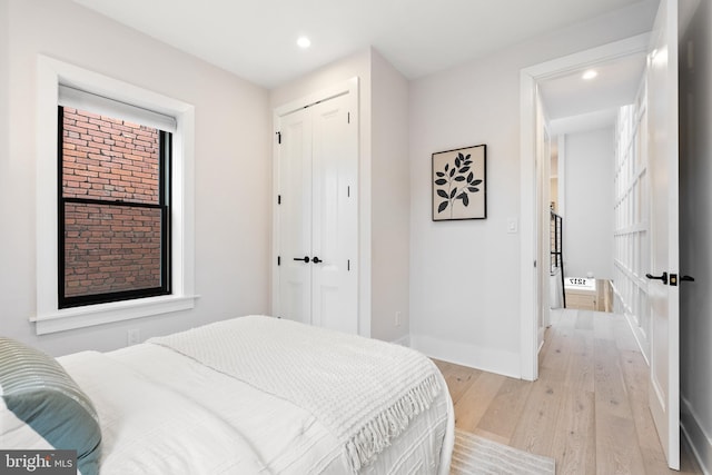 bedroom with a closet and light wood-type flooring