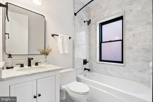 full bathroom with vanity, toilet, and tiled shower / bath