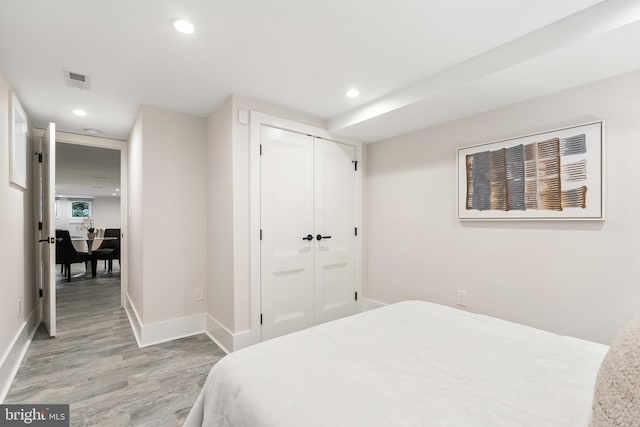 bedroom featuring hardwood / wood-style floors and a closet