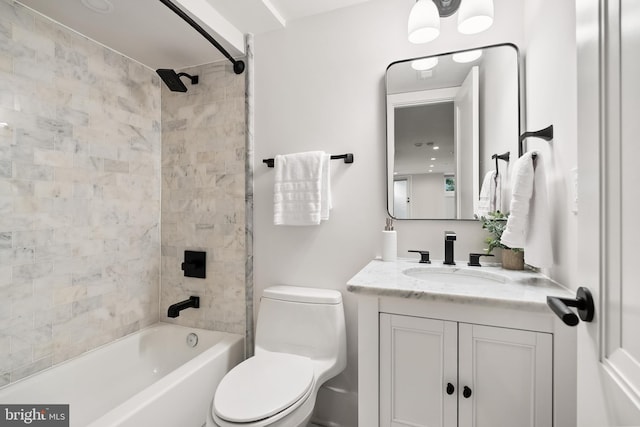 full bathroom featuring tiled shower / bath combo, vanity, and toilet