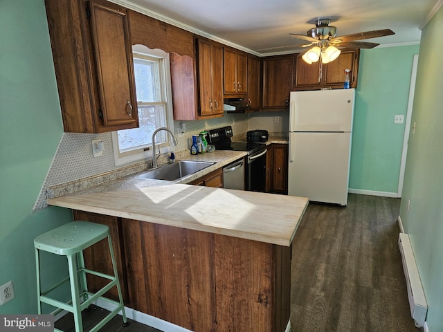 kitchen featuring ceiling fan, sink, a baseboard heating unit, kitchen peninsula, and appliances with stainless steel finishes