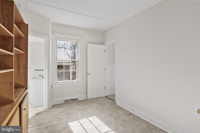 spare room featuring light colored carpet