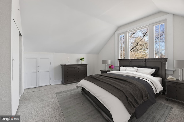 carpeted bedroom with vaulted ceiling