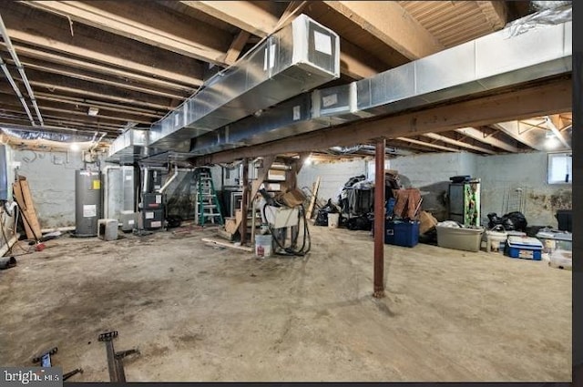 basement featuring heating unit and electric water heater