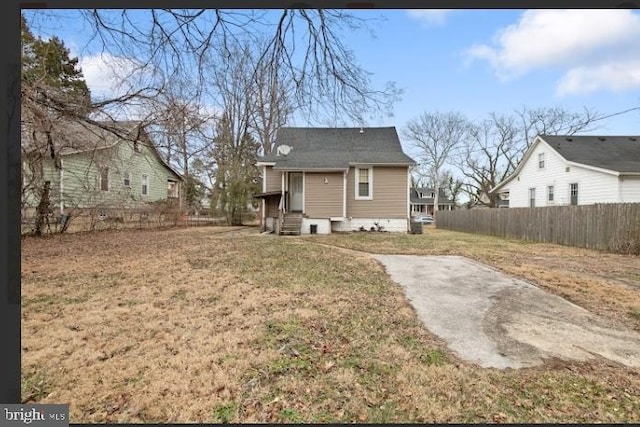 rear view of property with a yard