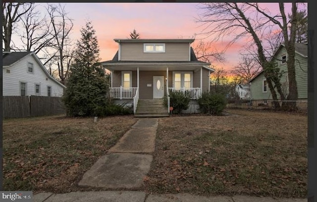 bungalow featuring a lawn and a porch