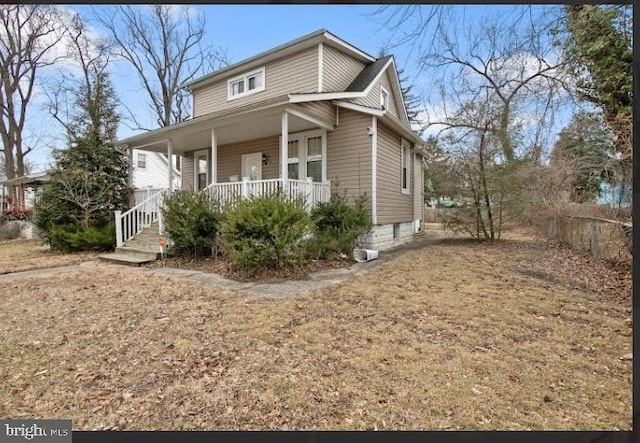 view of front of house with a porch and a front yard