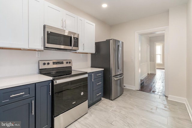 kitchen with white cabinets and appliances with stainless steel finishes