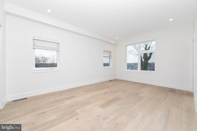 empty room with light hardwood / wood-style floors