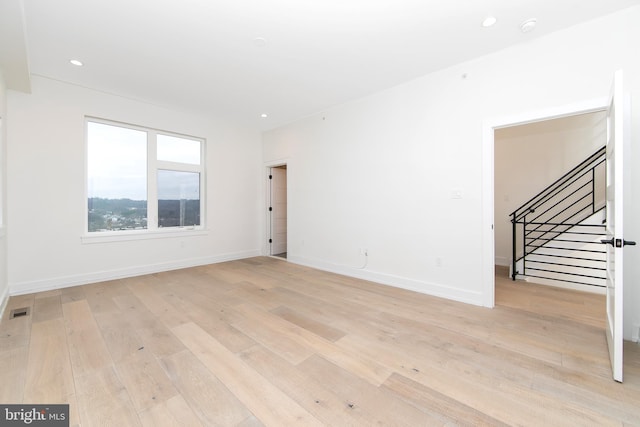 unfurnished room with light hardwood / wood-style flooring