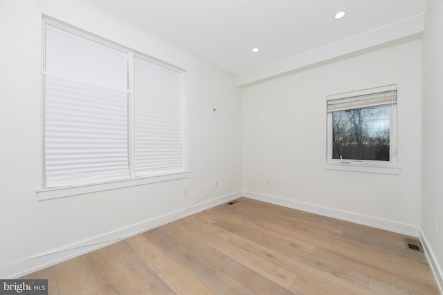 spare room with light hardwood / wood-style flooring