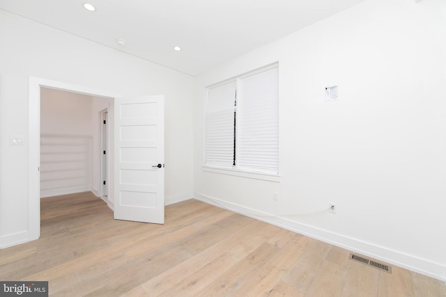 unfurnished room with light hardwood / wood-style floors