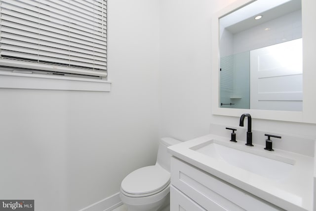 bathroom with toilet and vanity