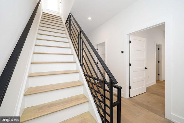 stairs featuring hardwood / wood-style flooring