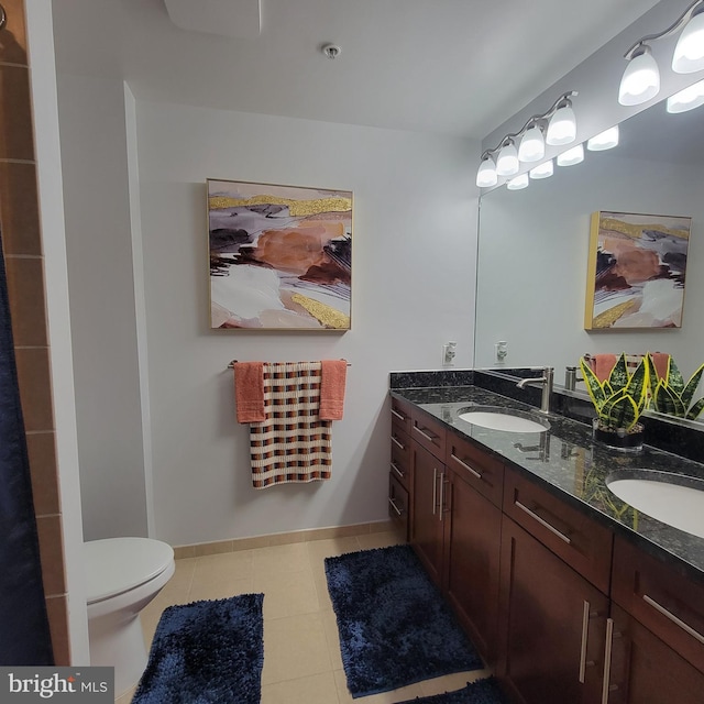 bathroom featuring vanity, toilet, and tile patterned floors