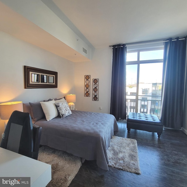 bedroom featuring access to outside and dark hardwood / wood-style flooring