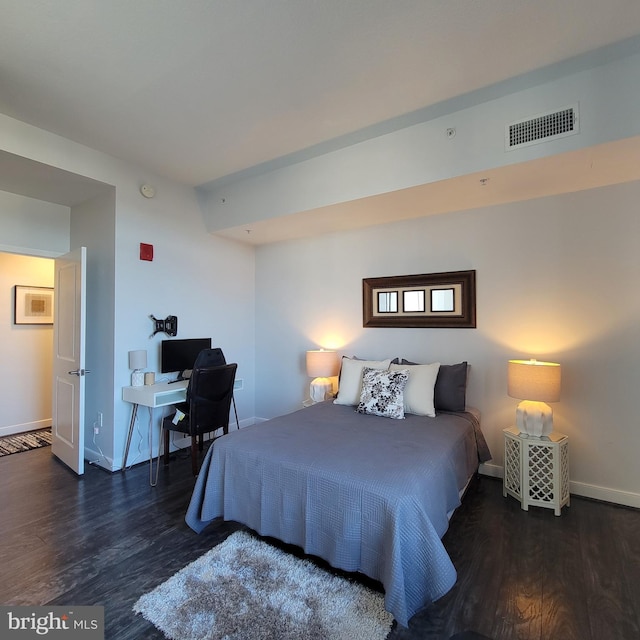 bedroom with dark hardwood / wood-style floors