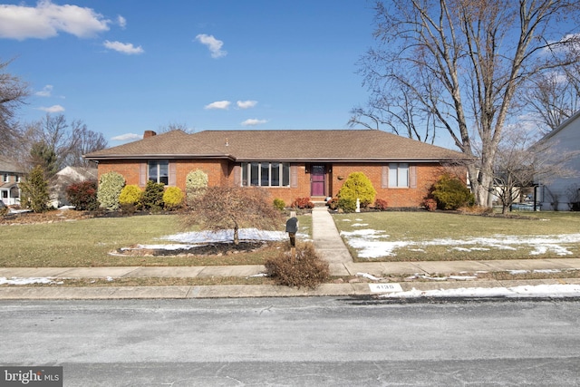 single story home with a lawn