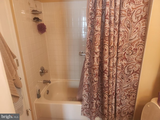 bathroom with shower / bath combination with curtain