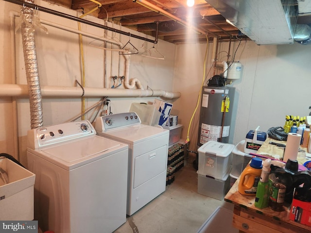 clothes washing area with sink, washing machine and dryer, and water heater