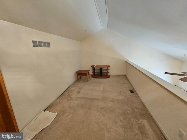 bonus room with vaulted ceiling, light colored carpet, and ceiling fan