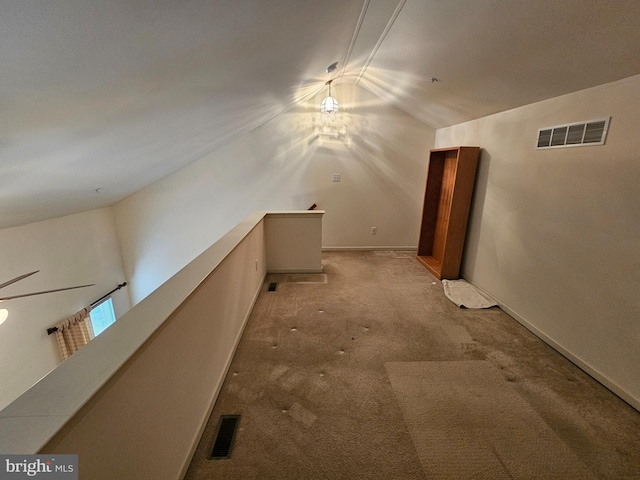 bonus room featuring vaulted ceiling and light colored carpet