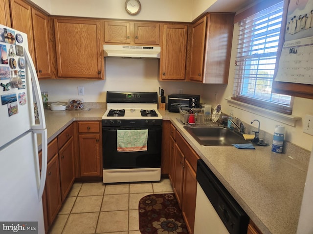 kitchen with white appliances, sink, and light tile patterned floors