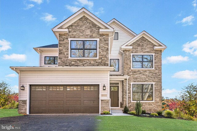 view of front of home featuring a garage and a front lawn