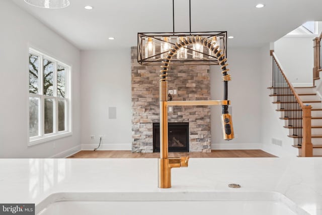 interior space featuring decorative light fixtures, a fireplace, and a chandelier