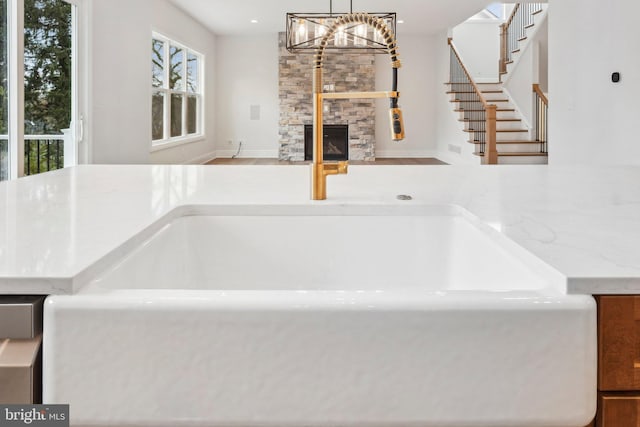 interior details with a stone fireplace and sink