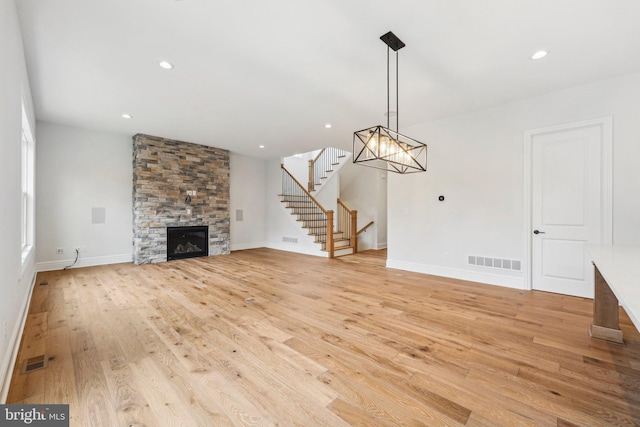 unfurnished living room featuring a fireplace and light hardwood / wood-style flooring