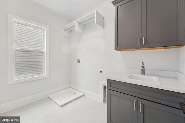 washroom featuring hookup for a washing machine, sink, cabinets, and hookup for an electric dryer