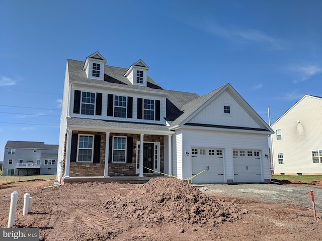 view of front of property with covered porch and a garage