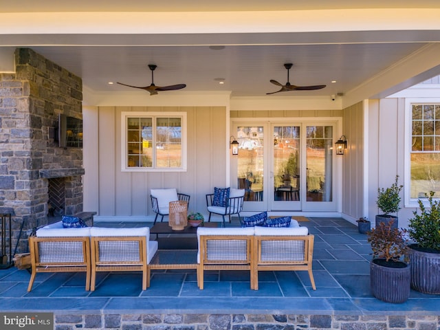 view of patio with an outdoor living space with a fireplace