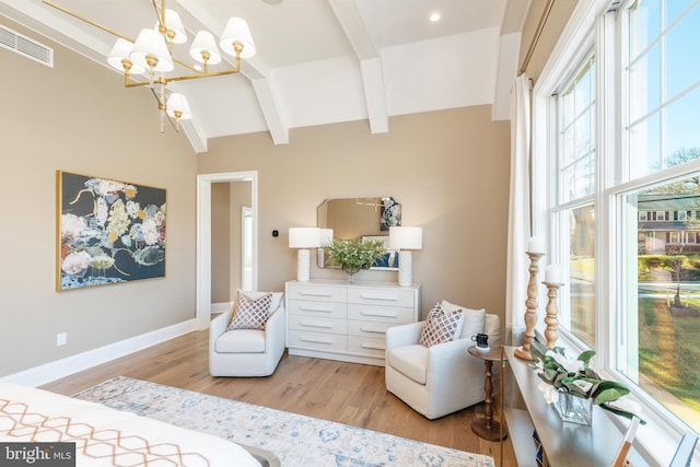 bedroom with beamed ceiling, light wood-type flooring, and an inviting chandelier