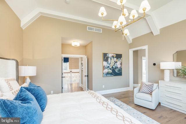 bedroom featuring hardwood / wood-style flooring and lofted ceiling