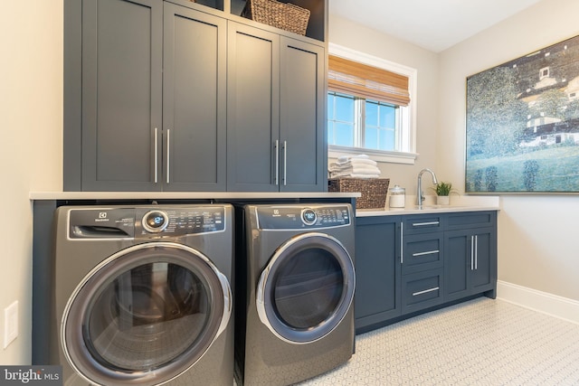 clothes washing area featuring cabinets, separate washer and dryer, and sink