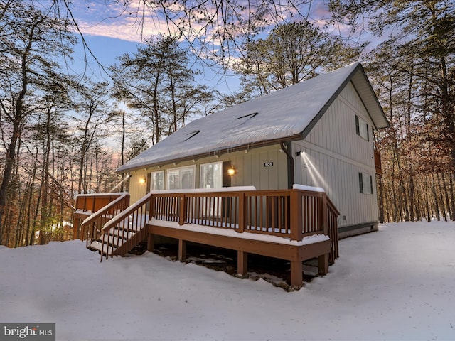 snow covered property featuring a deck