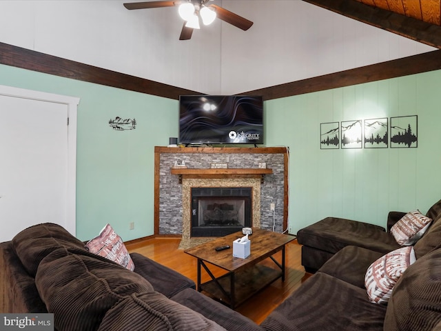 living room featuring a fireplace, hardwood / wood-style floors, vaulted ceiling with beams, and ceiling fan