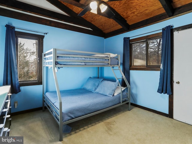 bedroom featuring carpet flooring, vaulted ceiling with beams, ceiling fan, and wood ceiling