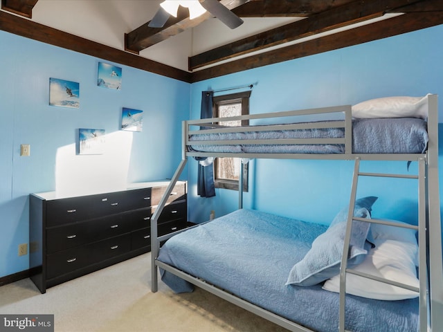 bedroom featuring ceiling fan, beamed ceiling, and light carpet