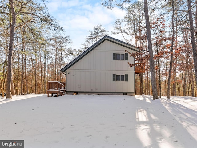 snow covered property with a deck