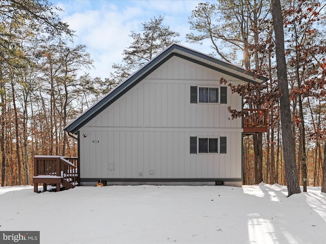 view of snow covered exterior featuring a wooden deck