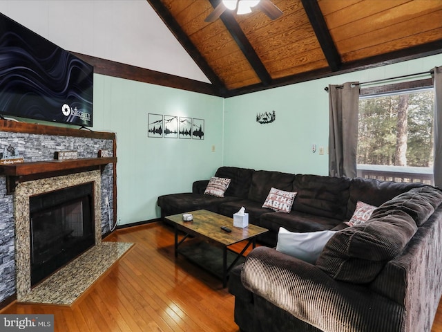 living room with ceiling fan, wooden ceiling, vaulted ceiling with beams, a fireplace, and hardwood / wood-style flooring